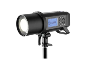 Vue de côté du flash AD 400 Pro avec écran LCD, monté sur une rotule avec des commandes accessibles et une tête de flash orientable pour un éclairage précis